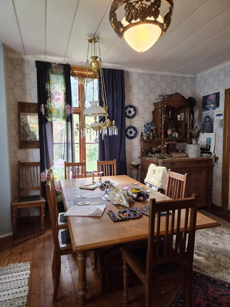Long wooden dining table and chairs in the historic house